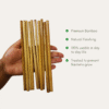 Reusable bamboo straws in hand